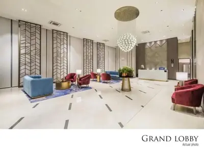 a lobby with red and blue chairs and a lobby at Executive 1 Bedroom with Pool Sauna Gym and More in Manila
