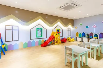 a childrens play room with a slide and tables at The Oasis 1 BR with Pool Sauna Gym and More in Manila