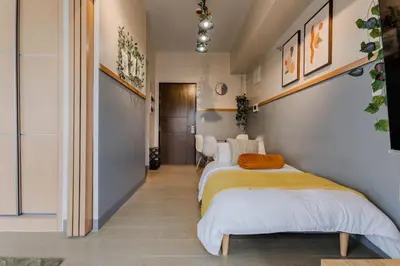 a bedroom with two beds and a hallway at The Oasis 1 BR with Pool Sauna Gym and More in Manila