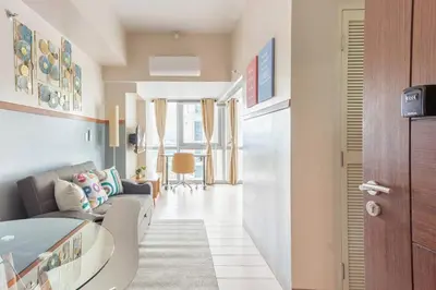 a living room with a couch and a table at The Sweet Escape 1 BR w Pool, Sauna, Gym and More in Manila