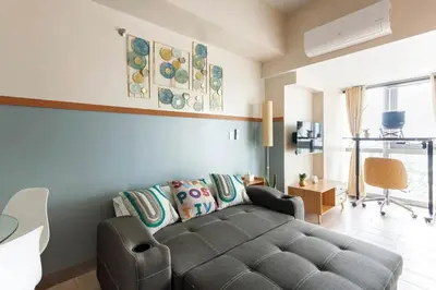 a living room with a couch and a table at The Sweet Escape 1 BR w Pool, Sauna, Gym and More in Manila