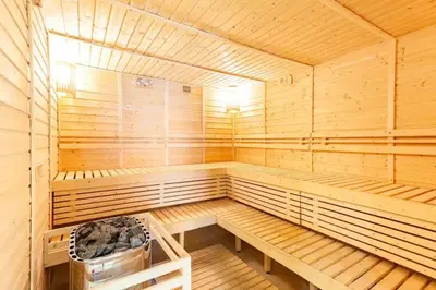 a wooden sauna with a bench in the middle at The Sweet Escape 1 BR w Pool, Sauna, Gym and More in Manila