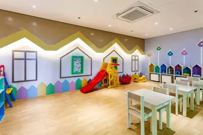 a childrens play room with a slide and tables at The Sweet Escape 1 BR w Pool, Sauna, Gym and More in Manila
