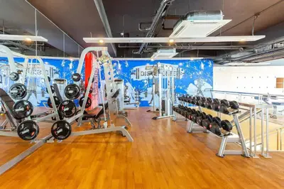 a gym with a bunch of treadmills and machines at The Sweet Escape 1 BR w Pool, Sauna, Gym and More in Manila