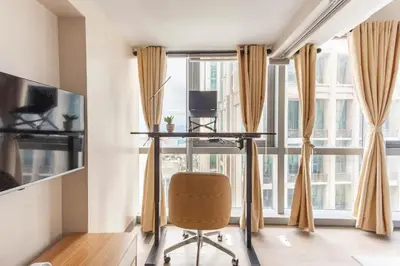 an office with a desk and a chair in front of a window at The Sweet Escape 1 BR w Pool, Sauna, Gym and More in Manila