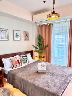 a bedroom with a large bed and a window at AZURE Urban Resort Residences Paranaque City in Manila