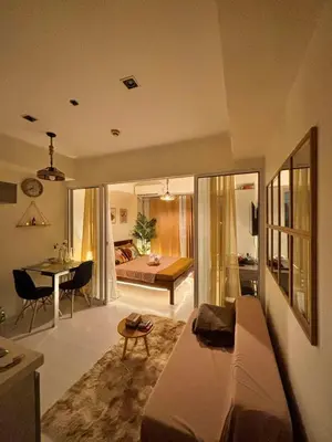 a living room with a couch and a dining room at AZURE Urban Resort Residences Paranaque City in Manila