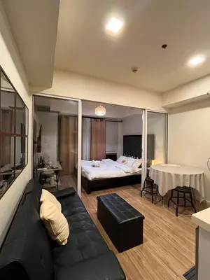 a living room with a couch and a bed at AZURE Urban Resort Residences Paranaque City in Manila