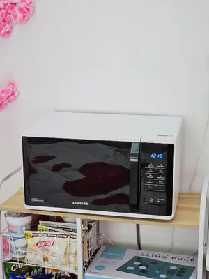 a microwave oven sitting on top of a shelf at Lakwatsero Caviteño Suites in Trece Martires