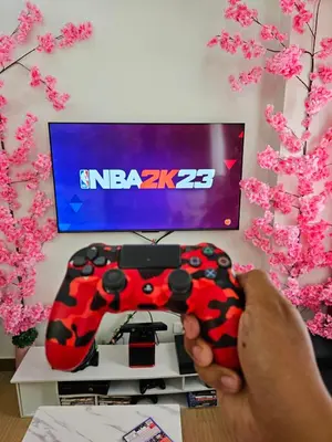 a person holding a video game controller in front of a tv at Lakwatsero Caviteño Suites in Trece Martires