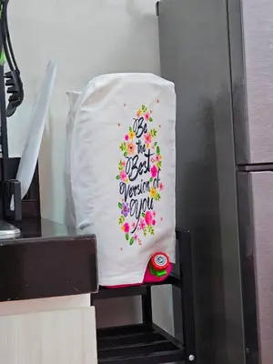 a white pillow with a floral design on a kitchen chair at Lakwatsero Caviteño Suites in Trece Martires
