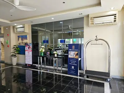 a lobby with a ticket counter in a building at Lakwatsero Caviteño Suites in Trece Martires