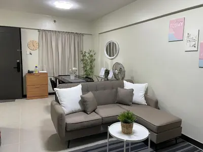 a living room with a couch and a table at Eves Urban Haven in Manila