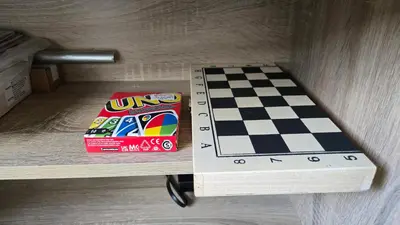 a chess board and a box on a shelf at Urban Oasis 2BR Condo with Multiple Pools at SMDC Charm Residences in Manila