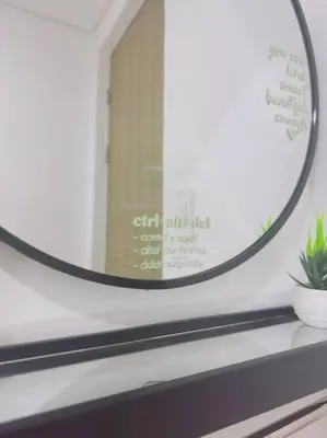 a mirror sitting on top of a shelf with a plant at Zenrise Staycation Condo in SMDC Hope Residences Trece Martires in San Agustin