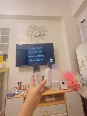 a person holding two wii controllers in front of a tv at Zenrise Staycation Condo in SMDC Hope Residences Trece Martires in San Agustin