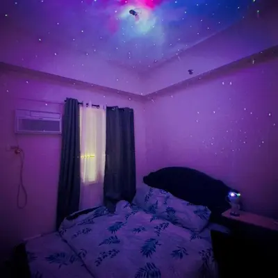 a purple bedroom with a bed with a star ceiling at Zenrise Staycation Condo in SMDC Hope Residences Trece Martires in San Agustin