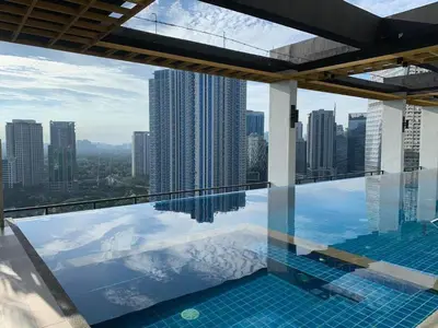 a swimming pool with a view of a city at GBA Condotel at Bonifacio Civic Center Tower in Manila