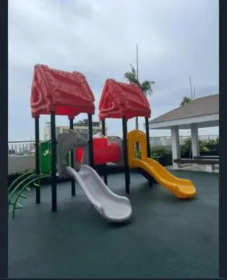 a group of playground equipment with slides and slidesktop at The Prestige Bayview with Balcony in Manila