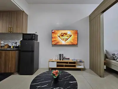 a living room with a refrigerator and a table at Q Workcation WFH Staycation in Manila