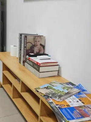 a pile of books sitting on a wooden table at Q Workcation WFH Staycation in Manila