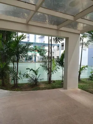a building with palm trees in front of a building at Kasara Urban Resort & Residences in Manila