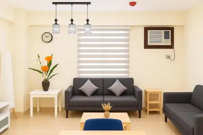 a living room with a couch and a table at Kasara Urban Resort & Residences in Manila