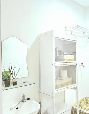 a white bathroom with a mirror and a sink at SW Staycation Sam Suite SMDC Hope Residences Beside SM City in Trece Martires