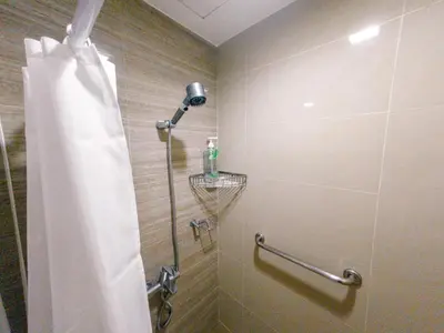 a shower with a shower curtain in a bathroom at COZI Venice Luxury Residences Alessandro BGC w Pool Gym in Manila