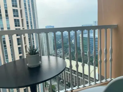 a potted plant sitting on a table on a balcony at Condo Hotel type luxury Big Studio in Mckinley Hill taguig in Manila
