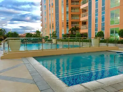 a swimming pool in front of some buildings at Condo Hotel type luxury Big Studio in Mckinley Hill taguig in Manila