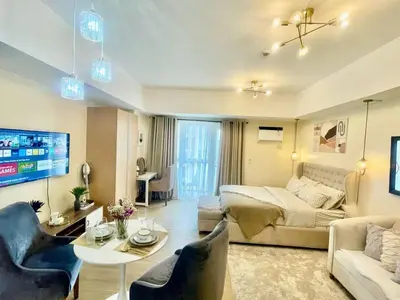 a living room with a couch and a table at Condo Hotel type luxury Big Studio in Mckinley Hill taguig in Manila