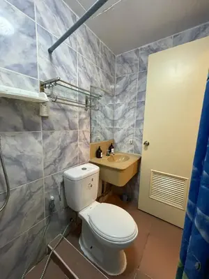 a bathroom with a toilet and a sink at 1BR Condotel - Forbes Town Road near St Lukes BGC Taguig in Manila