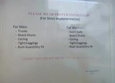 a white paper with the words women wear proper dress code at Cozy Private Hotel Suite with Bath Tub and Free Pool Access in Manila