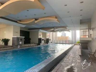 a large swimming pool in a hotel room at Birch Tower by Bright Space Manila in Manila