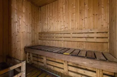 a wooden sauna with a wooden bed in it at Birch Tower by Bright Space Manila in Manila