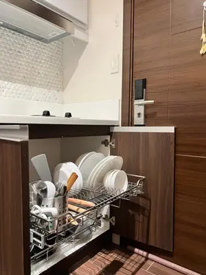 a dishwasher filled with plates and pans in a kitchen at AM Condotel at Air Residences in Manila