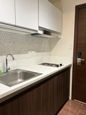 a kitchen with a sink and a counter top at AM Condotel at Air Residences in Manila