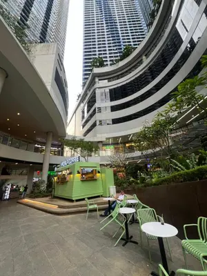 a group of tall buildings with tables and chairs at AM Condotel at Air Residences in Manila