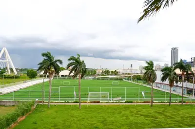 a soccer field in a park with palm trees at Modern Nordic 1 Bedroom Condo near Eastwood, Quezon City in Manila