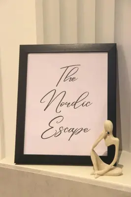 a framed picture of a woman sitting on a shelf at Modern Nordic 1 Bedroom Condo near Eastwood, Quezon City in Manila