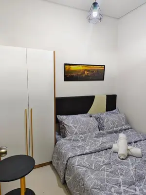 a bedroom with a bed with a stuffed animal on it at Cozy Easy Escape in Manila