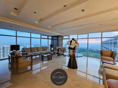 a living room with couches and tables and windows at Cozy Easy Escape in Manila
