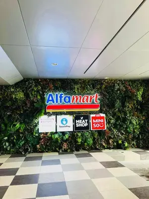 a wall of signs in a mall with a green wall at Cozy Easy Escape in Manila