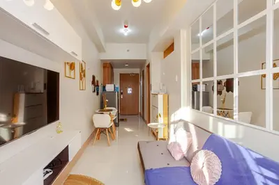 a large living room with a couch and a kitchen at Staycation At Shore by LAYANDY in Manila
