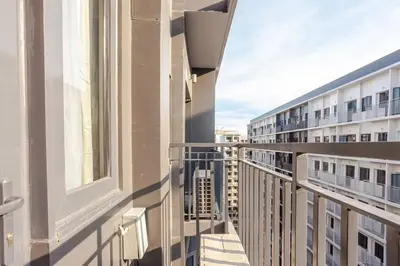 a balcony with a view of a building at Staycation At Shore by LAYANDY in Manila