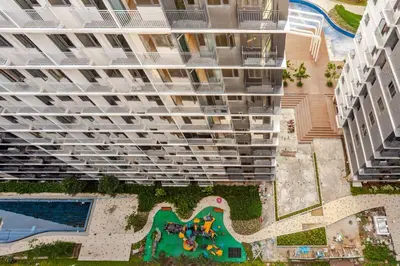 an aerial view of a large apartment building with a pool at Staycation At Shore by LAYANDY in Manila