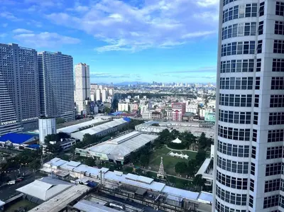 a view of a city with a tall building at 1BR Premium condo - Twin Oaks Pl PANORAMIC VIEW in Manila