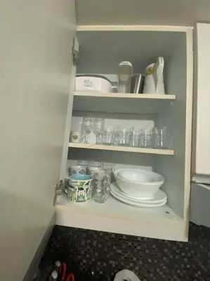 a cabinet with plates and bowls and other items on it at 1BR Premium condo - Twin Oaks Pl PANORAMIC VIEW in Manila