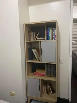 a book shelf filled with books in a room at 1BR Premium condo - Twin Oaks Pl PANORAMIC VIEW in Manila
